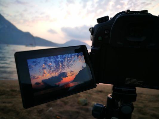 Video camera recording dusk on the beach